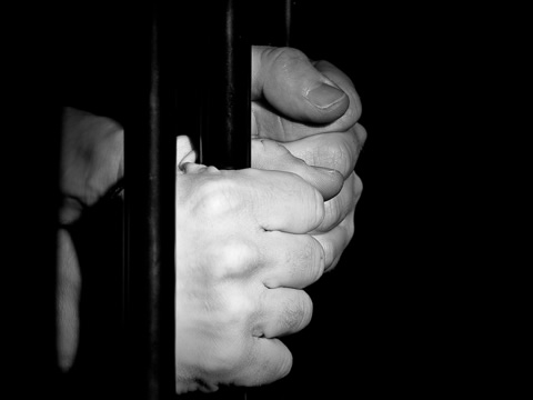 hands on prison bars